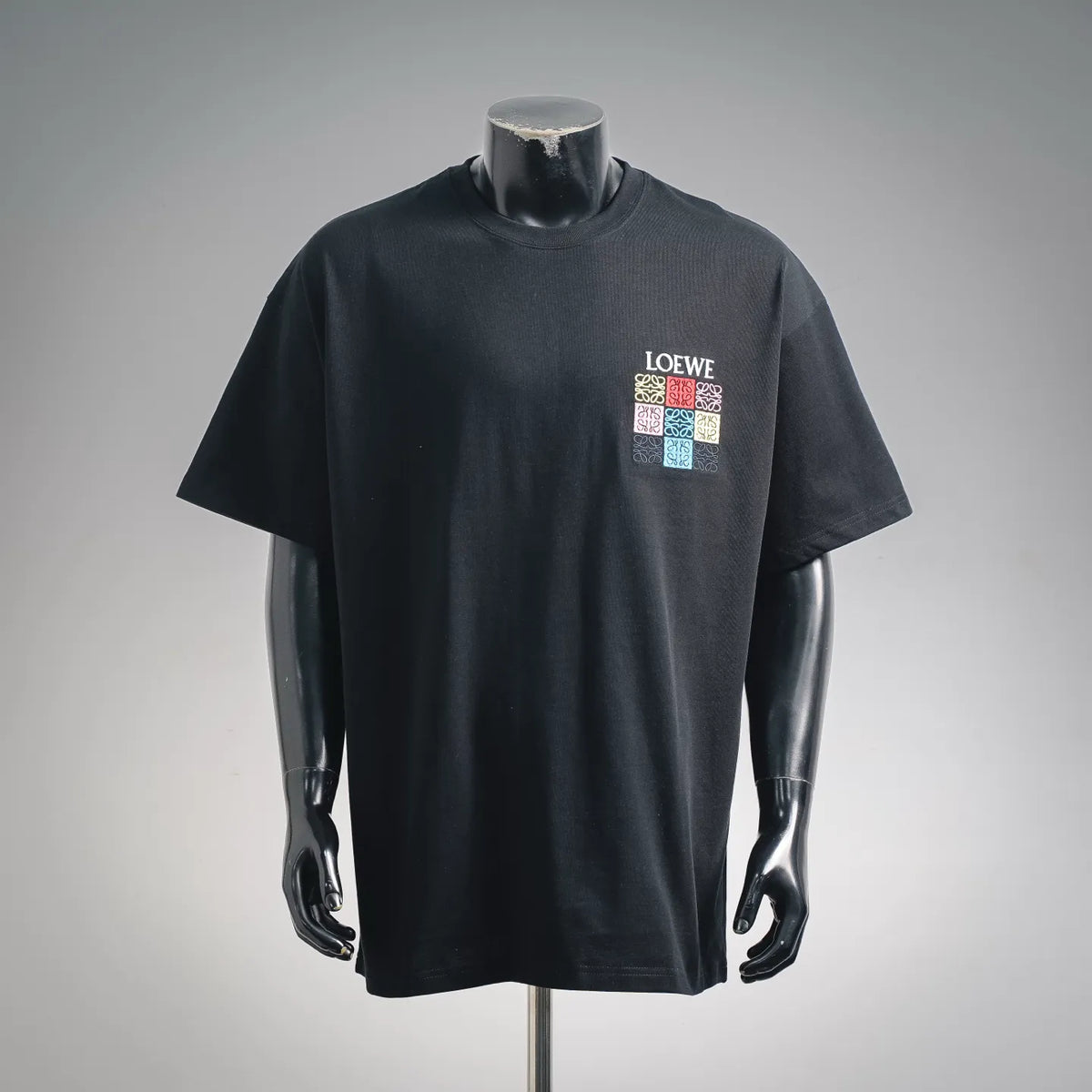 Black LOEWE short-sleeve T-shirt with multicolor square logo on chest.
