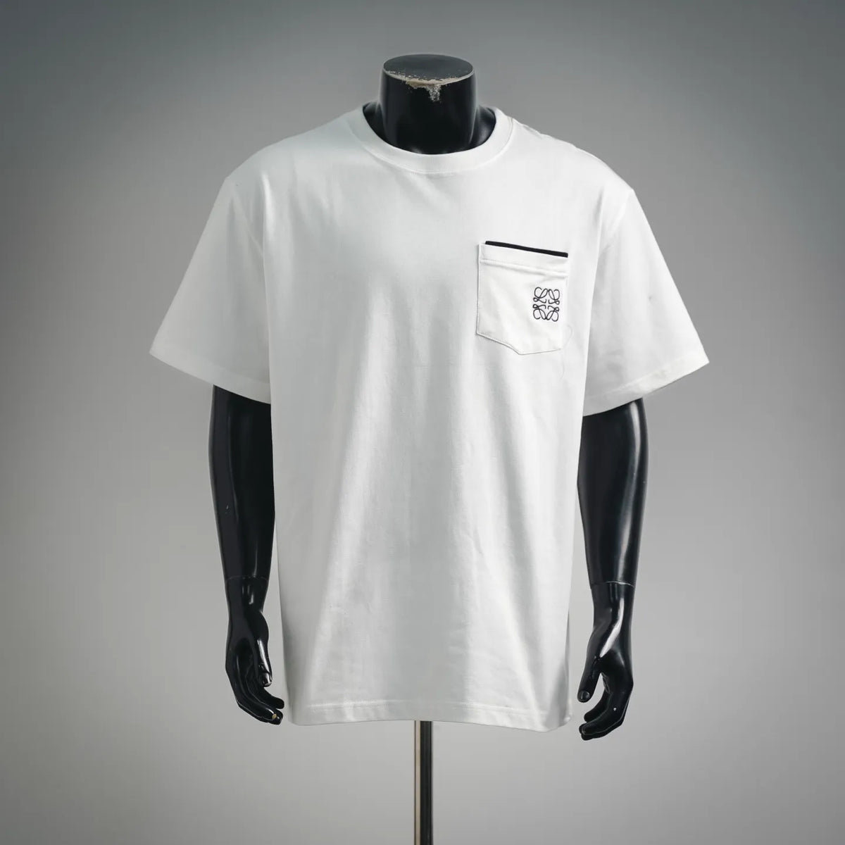 White short-sleeve T-shirt on mannequin with chest pocket and embroidered logo
