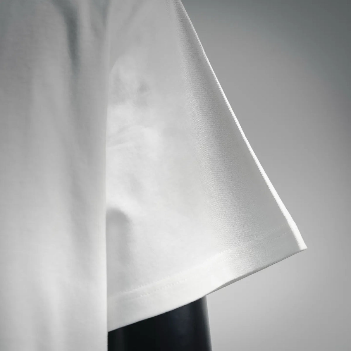 White short-sleeve T-shirt side view with curved hemline