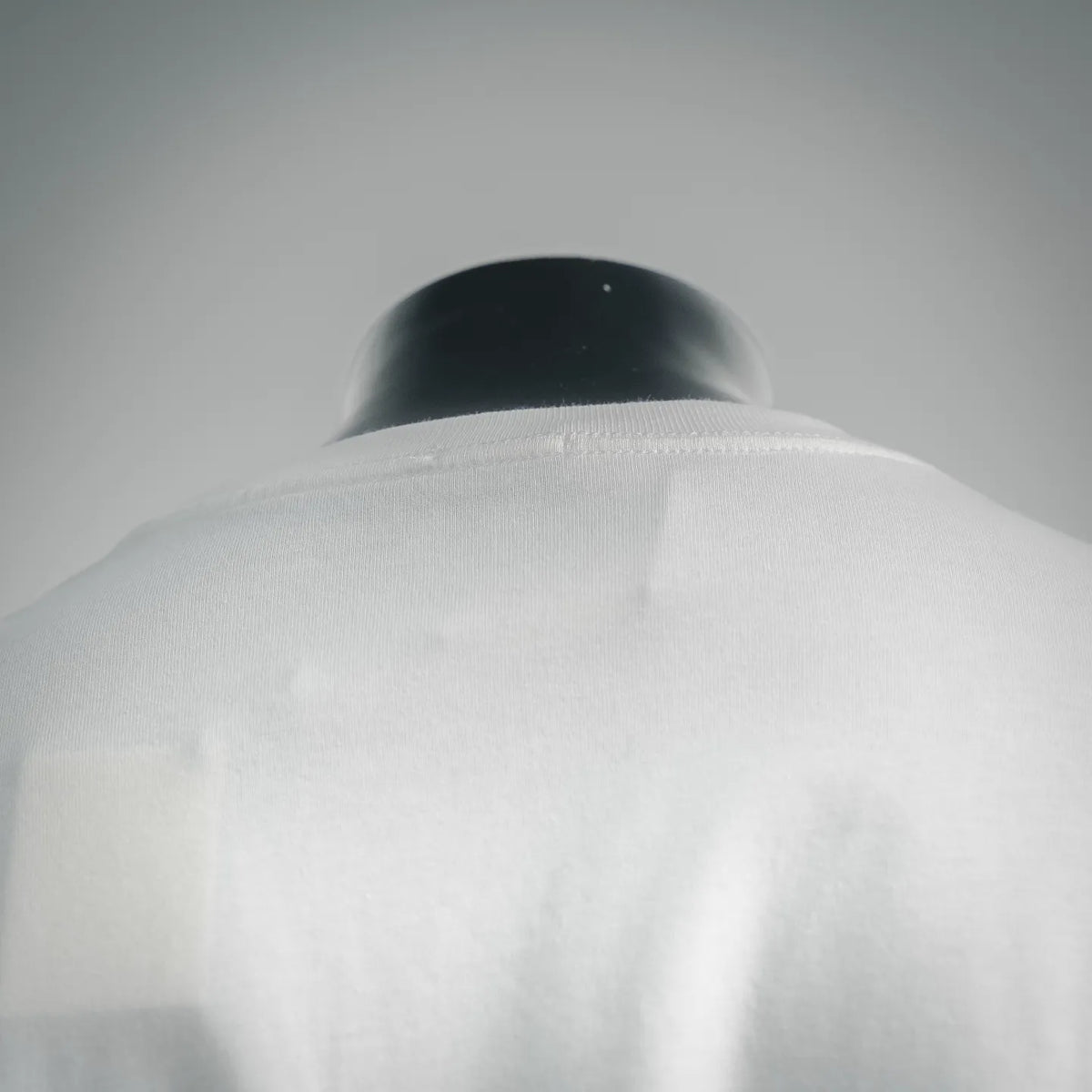 White short-sleeve T-shirt neckline close-up with ribbed collar