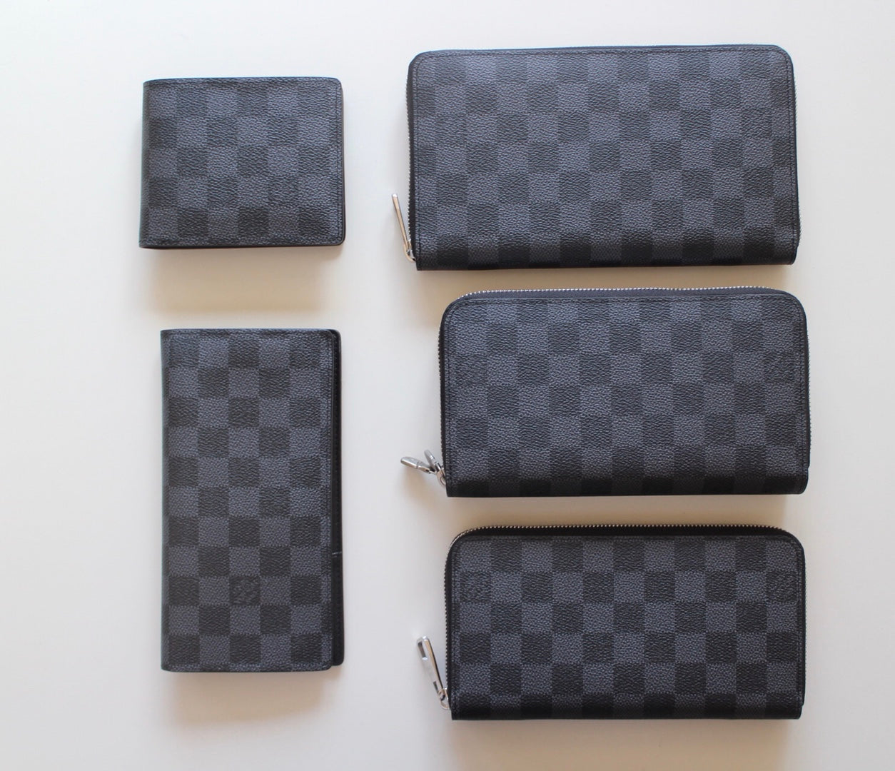 Louis Vuitton small zip wallets in dark checker pattern, set of four