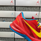 Red low-top sneaker with blue outsole, yellow swoosh, and yellow laces.