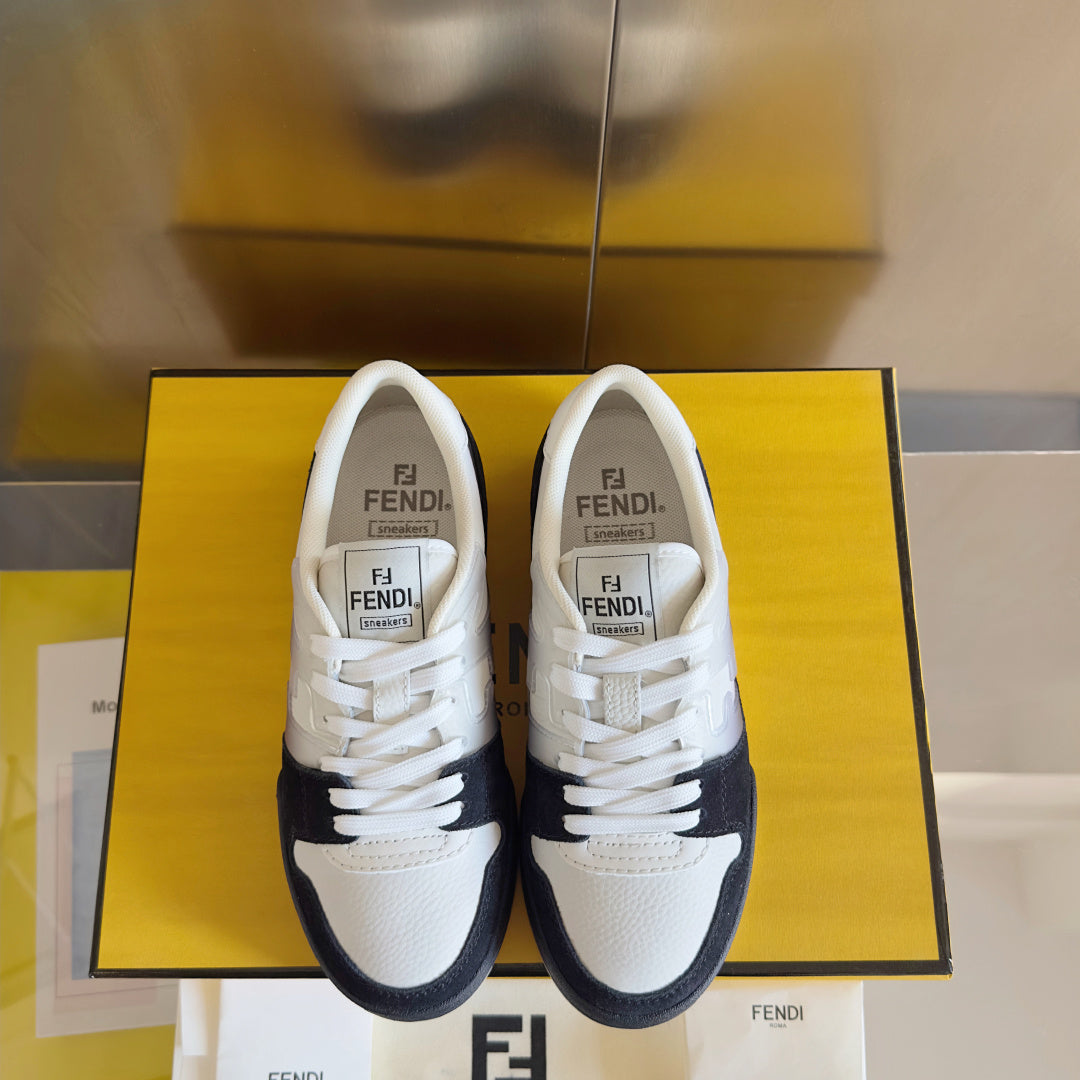 Low-top sneakers facing forward: white uppers with black trim and FENDI logo on tongue