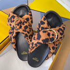 Fendi leopard-print slide sandals with black base and gold ring buckle ornaments
