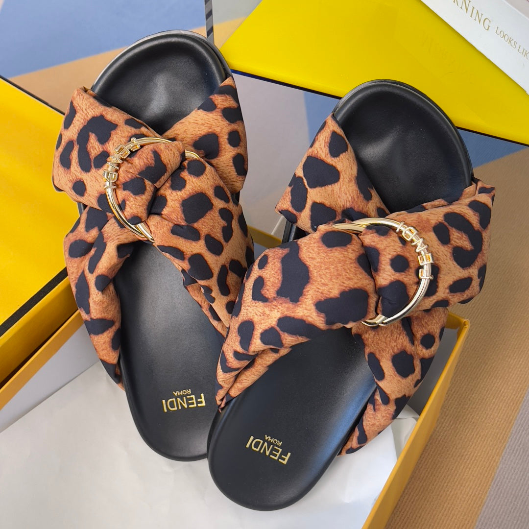 Fendi leopard-print slide sandals with black base and gold ring buckle ornaments