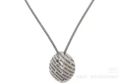 Round logo-printed pendant necklace with silver-tone chain, close-up