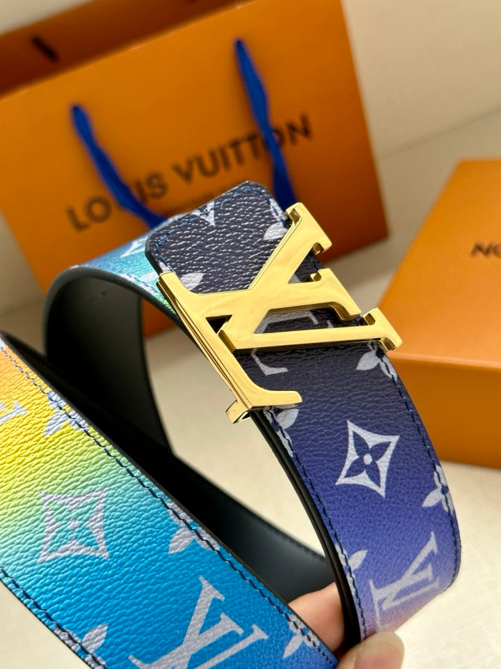 Close-up belt buckle with gold-tone hardware and blue monogram strap