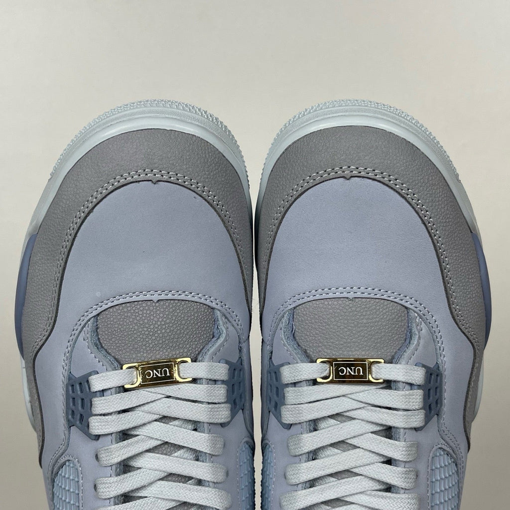 Light blue Air Jordan 4 sneakers with gray toe caps and gold heel pull label