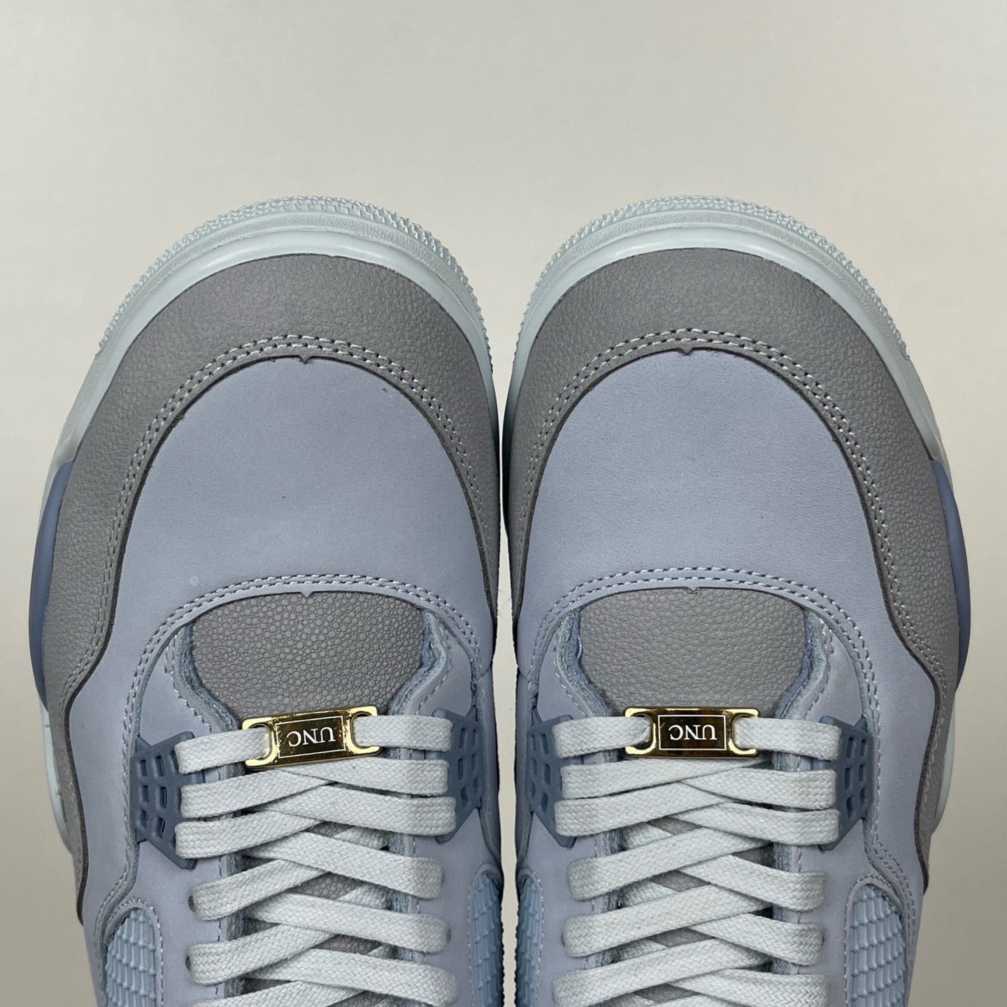 Light blue Air Jordan 4 sneakers with gray toe caps and gold heel pull label