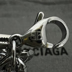 Silver clasp detail with BALENCIAGA logo engraving and chain link, close-up