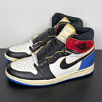 High-top sneaker angle view: black and white leather, red and cream ankle panels, blue outsole