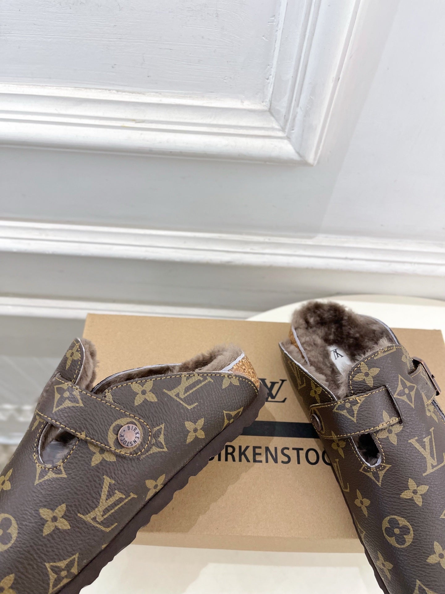 Louis Vuitton monogram sandals with emblem accent, two straps, and faux-fur lining