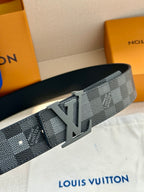 Designer belt with gray Damier pattern and silver LV buckle, close-up