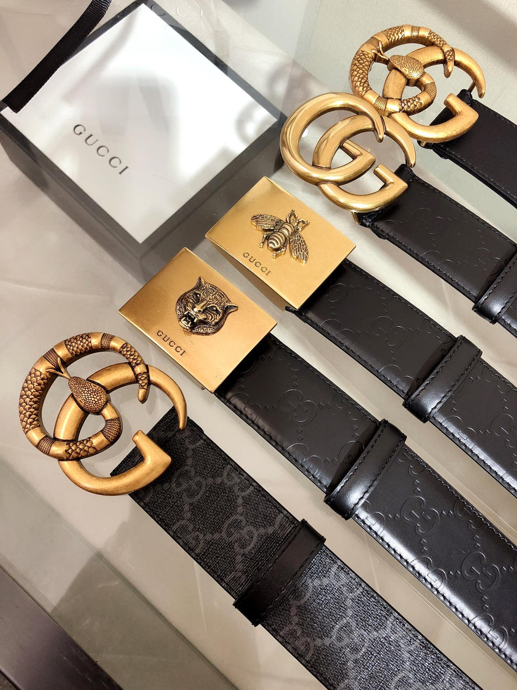 Black belt with textured gold buckle and ridged strap details