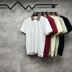 Polo shirts on hangers in white, burgundy, light yellow, black, and mint with collars