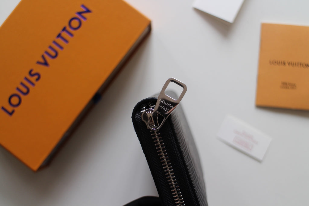 Dark textured leather zip wallet side view with zipper track and metal pull