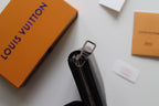 Dark textured leather zip wallet side view with zipper track and metal pull