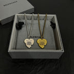 Heart pendant necklace set with gold and silver chains, two heart pendants in box.