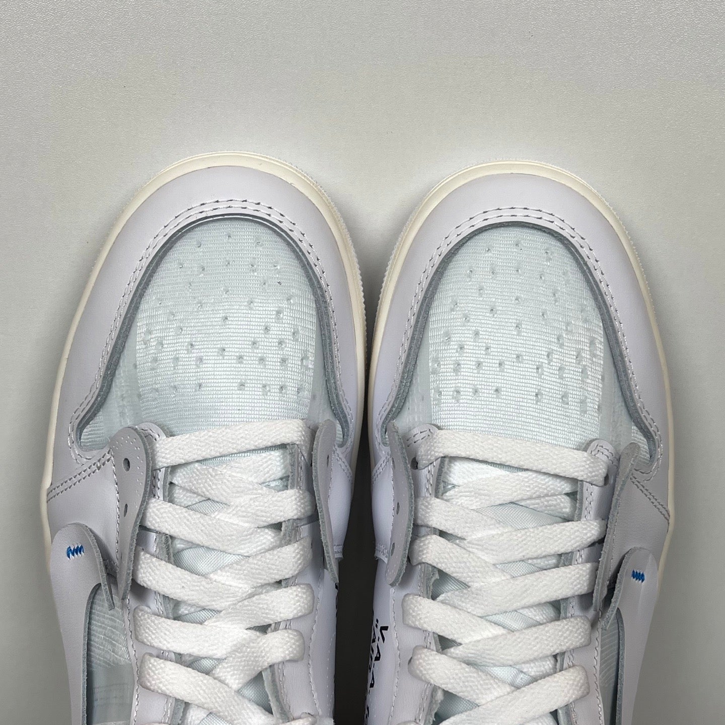 High-top sneakers top view, white laces and tongue with light blue interior padding