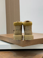 Back view of suede ankle boots with Moncler branding on the heel panels.