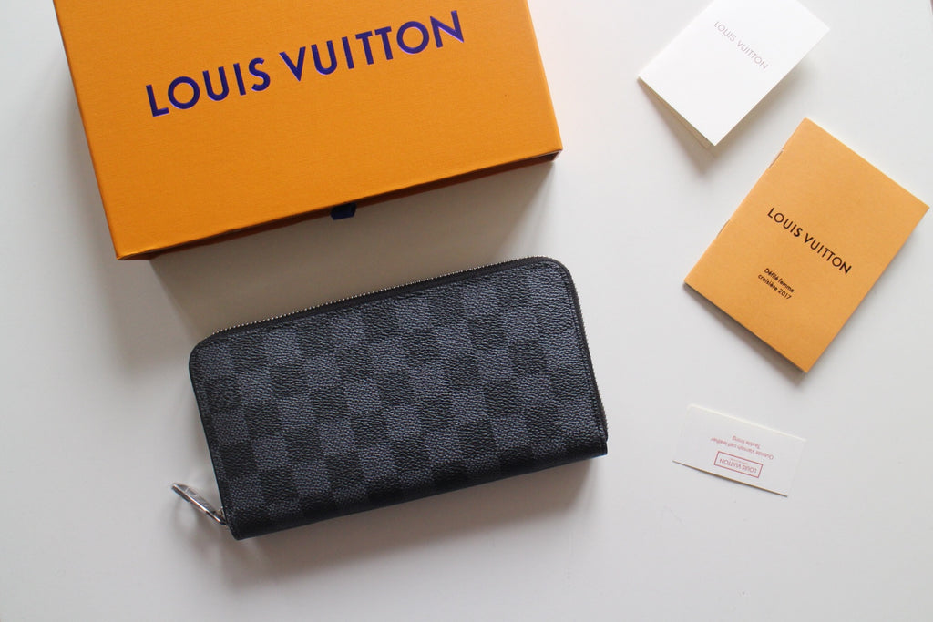 Small Louis Vuitton zip wallet in dark monogram canvas with silver zipper hardware.