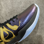 Basketball sneaker close-up of side panel in dark purple with gold swoosh detail
