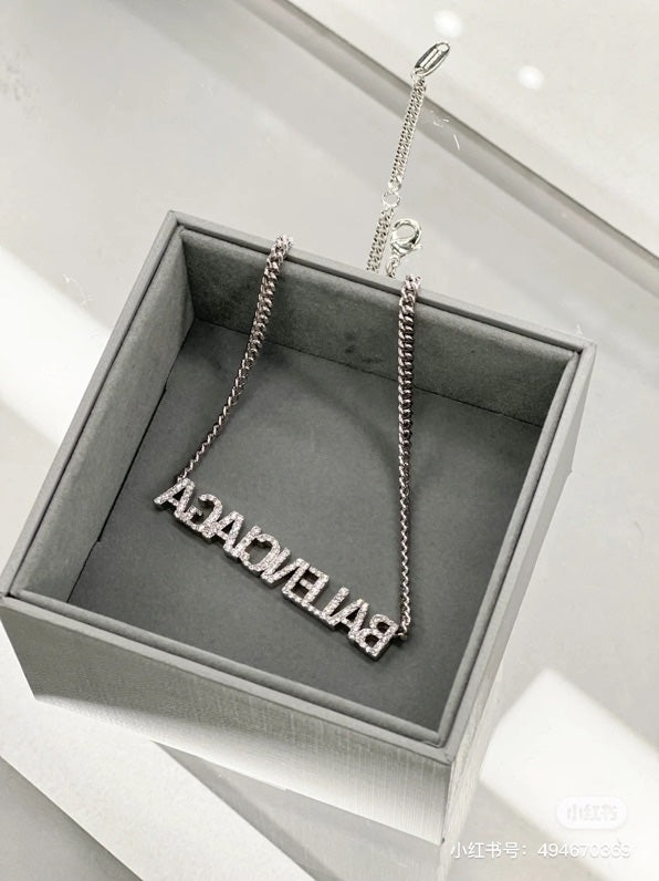 Silver Balenciaga logo pendant necklace in a gray gift box