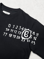 Black crew-neck T-shirt with large white number and logo print