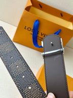 Belt strap edge with gray stitching and silver buckle prong