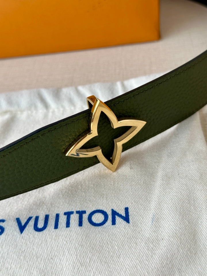 Green leather belt with gold star buckle detail on textured leather