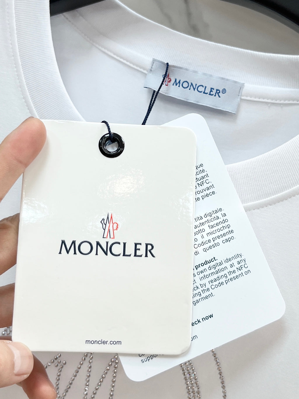 White T-shirt with Moncler brand tag attached at neckline