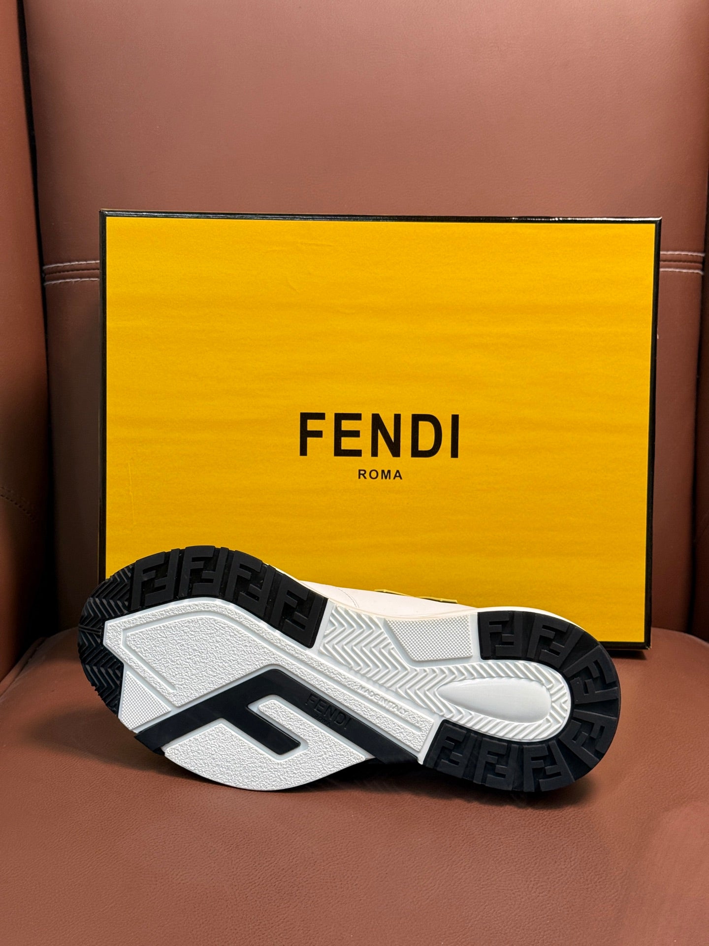 High-top sneaker outsole with textured tread and logo pattern