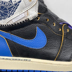 High-top sneakers close-up: black leather upper with blue swoosh and yellow stitch trim