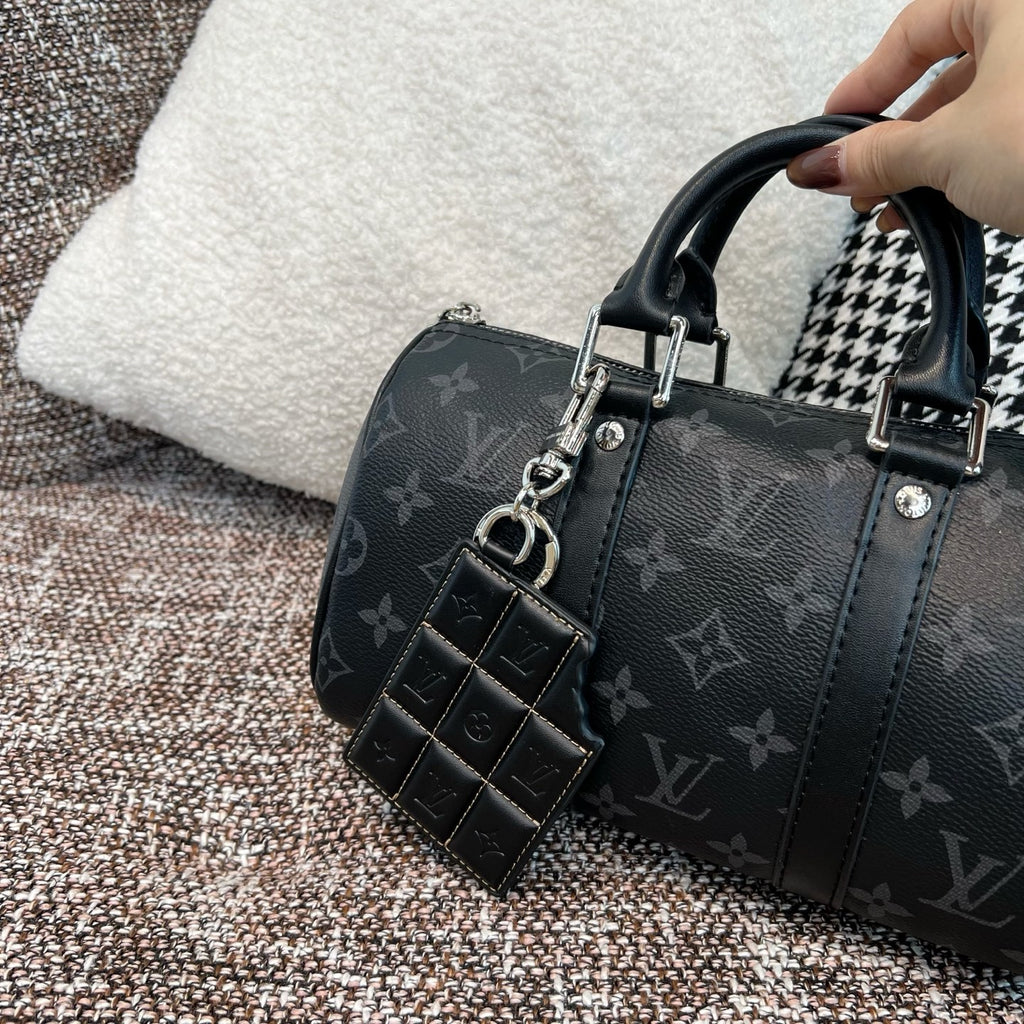 Louis Vuitton monogram handbag with black leather key holder charm and studded details