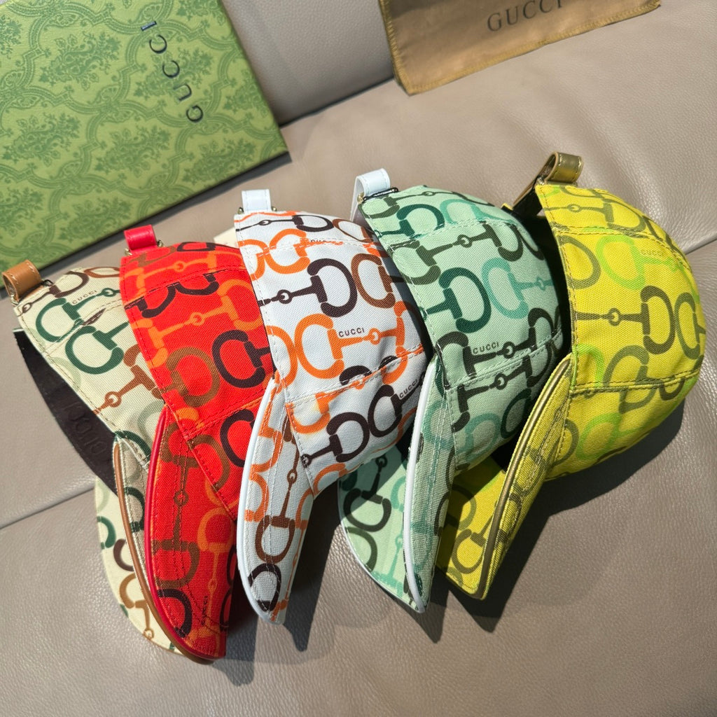 Set of Gucci caps with link logo prints in red, green, and yellow, curved brims.