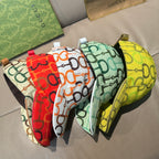 Set of three patterned caps: green, red, and yellow with curved brims