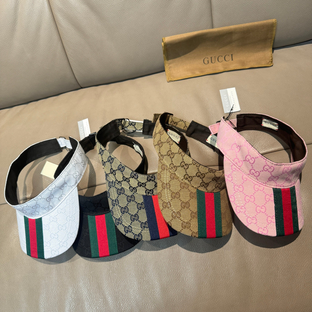 Assorted Gucci visor caps with GG logo and green-red stripe in pink, blue, and brown
