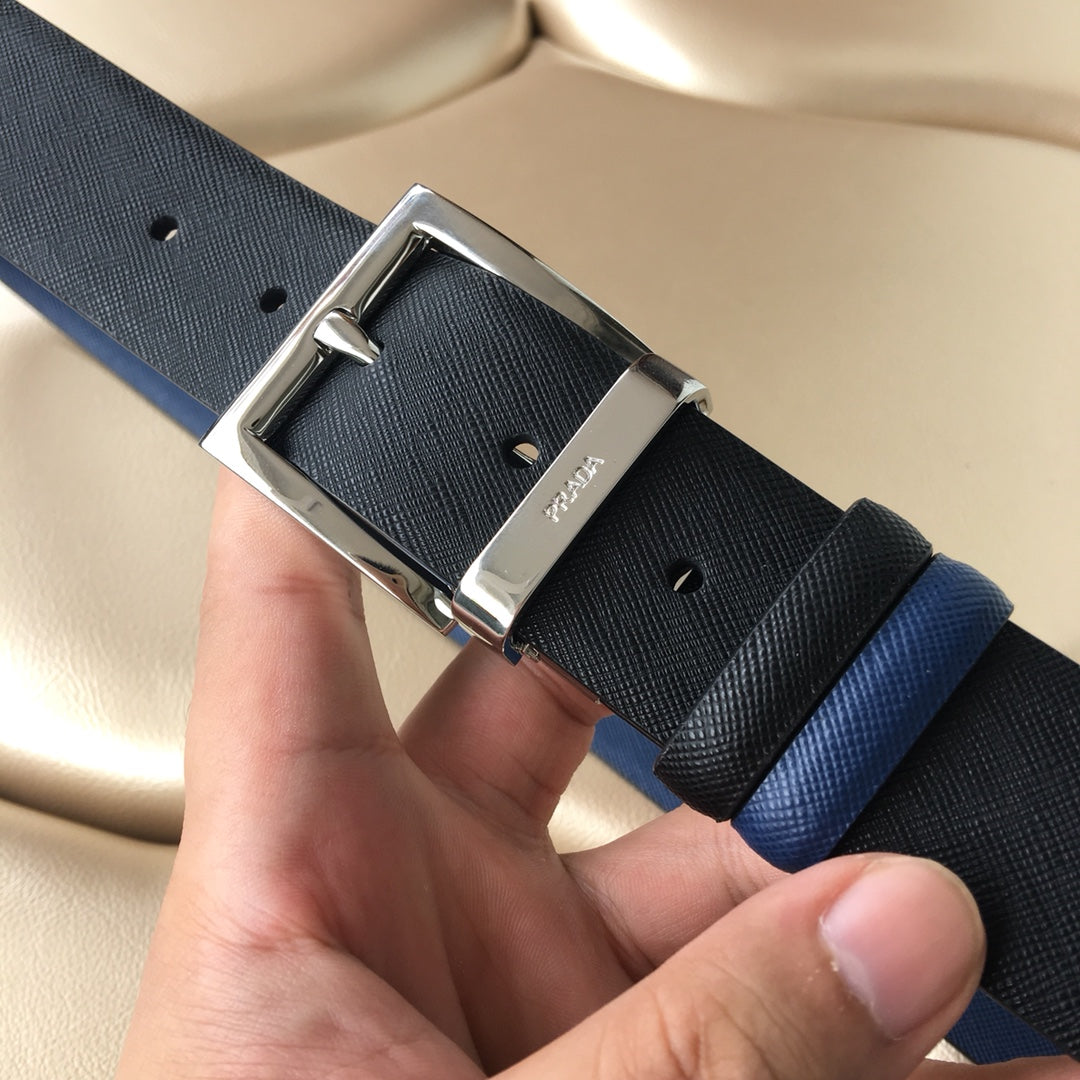 Two-tone belt with silver buckle, textured strap with punched holes in black and blue