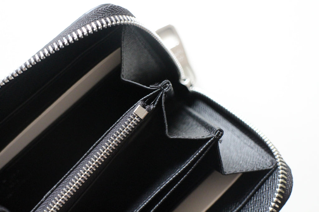 Small Louis Vuitton zip wallet open interior with zip track and compartment pockets.
