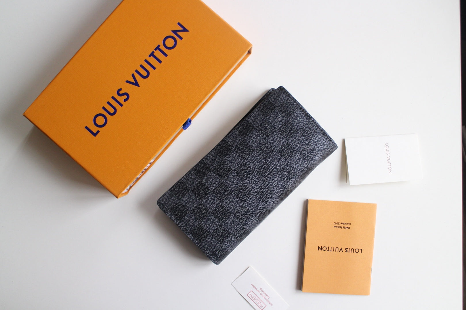 Louis Vuitton small wallet in dark checkered canvas, angled view