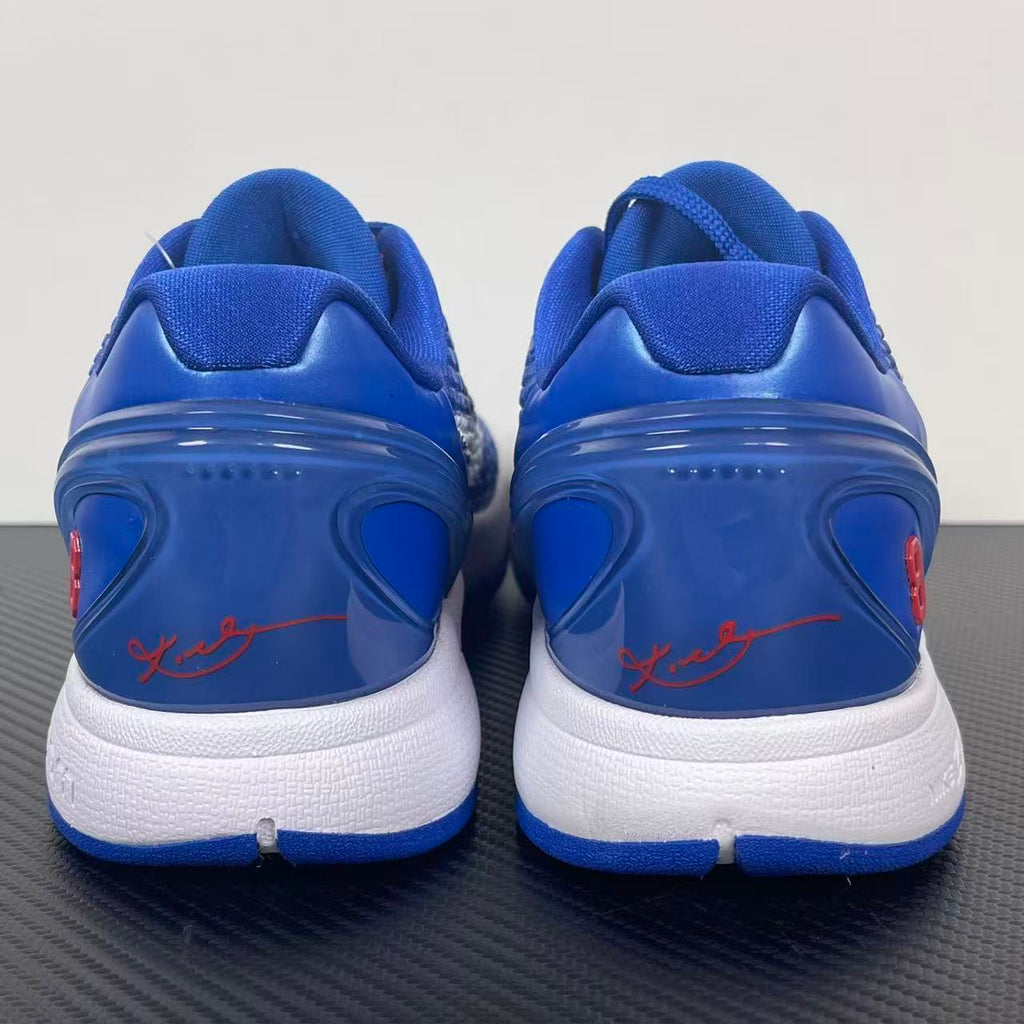 Blue Nike basketball sneaker back view with red script on white heel area