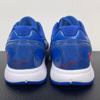 Blue Nike basketball sneaker back view with red script on white heel area