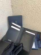 Small bag open inside: dark leather card slots and Dior logo on flap