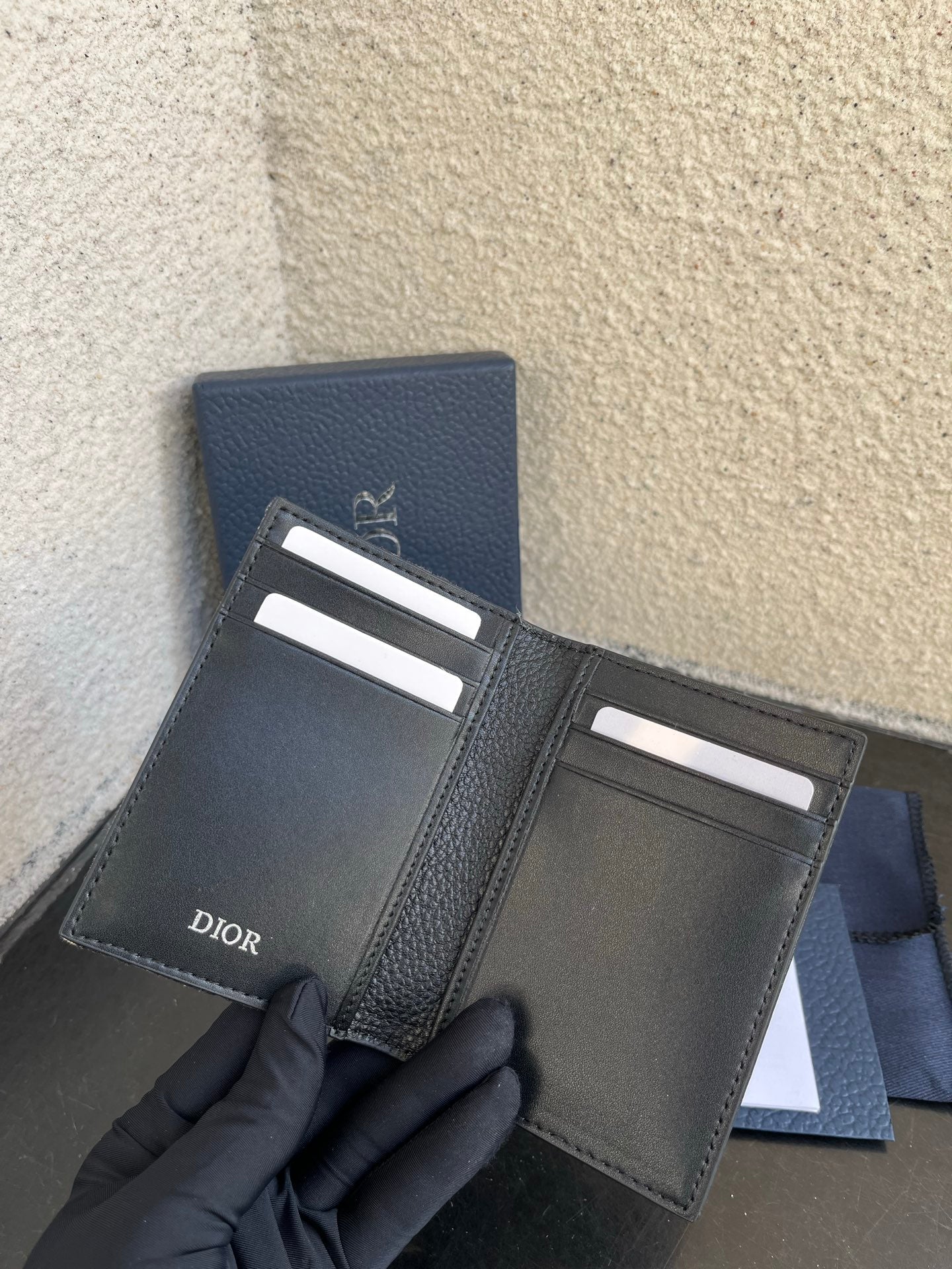Small bag open inside: dark leather card slots and Dior logo on flap
