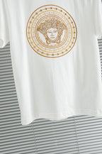 Versace white T-shirt close-up of gold Medusa circular chest graphic