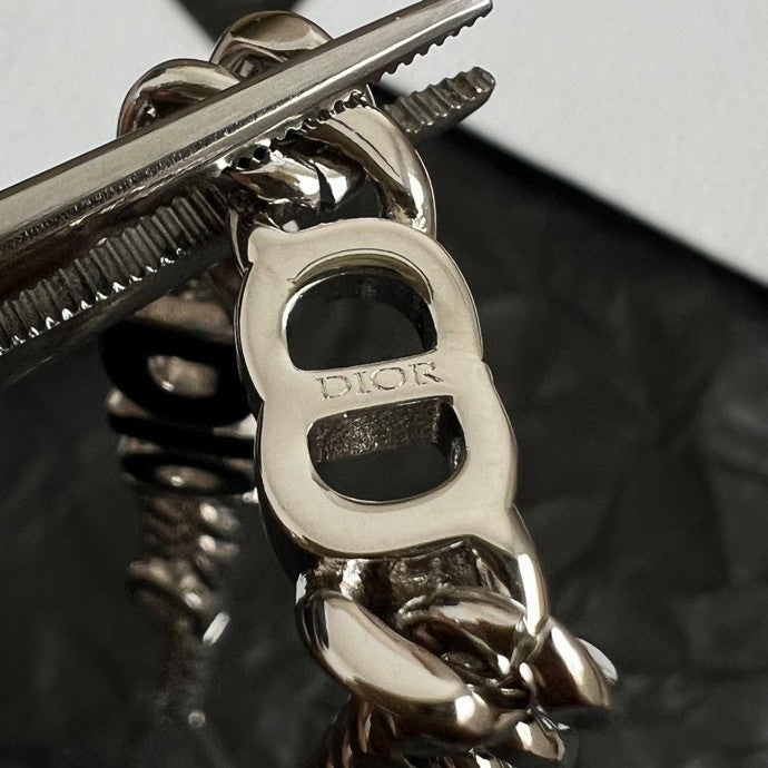Silver-tone DIOR bracelet clasp and chain links close-up