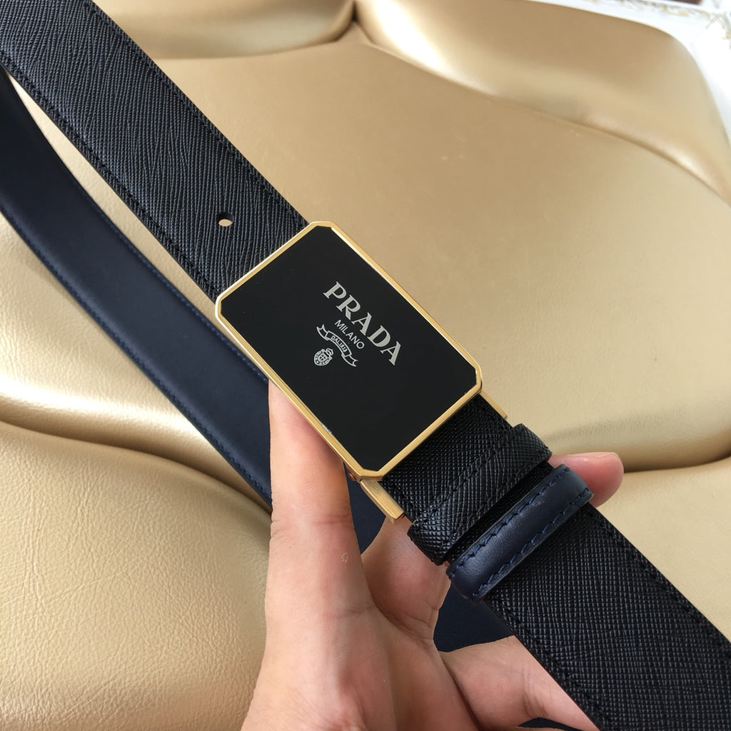 Prada leather belt close-up: black textured strap with gold-toned buckle logo plaque