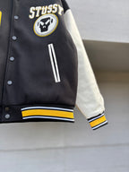 Varsity jacket sleeve with white stripe detail and striped rib cuff on black