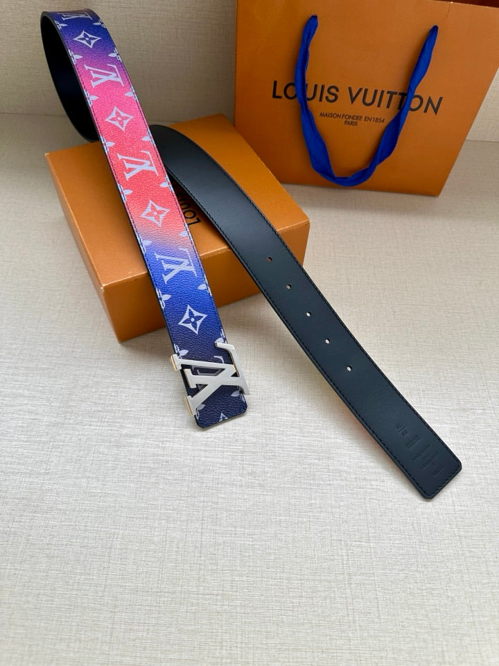 Designer belt pair: blue patterned strap with gold-tone buckle and second plain strap