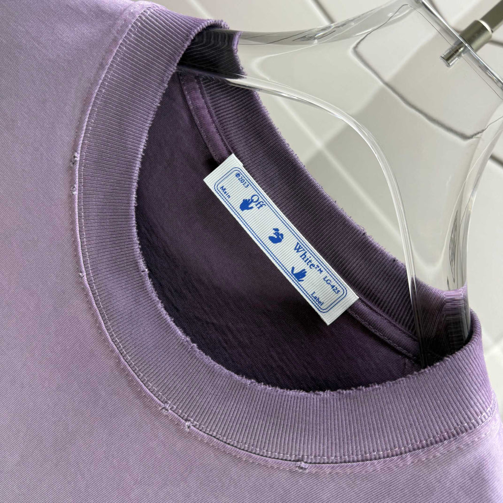 Off White lavender T-shirt neckline close-up with interior brand tag at collar
